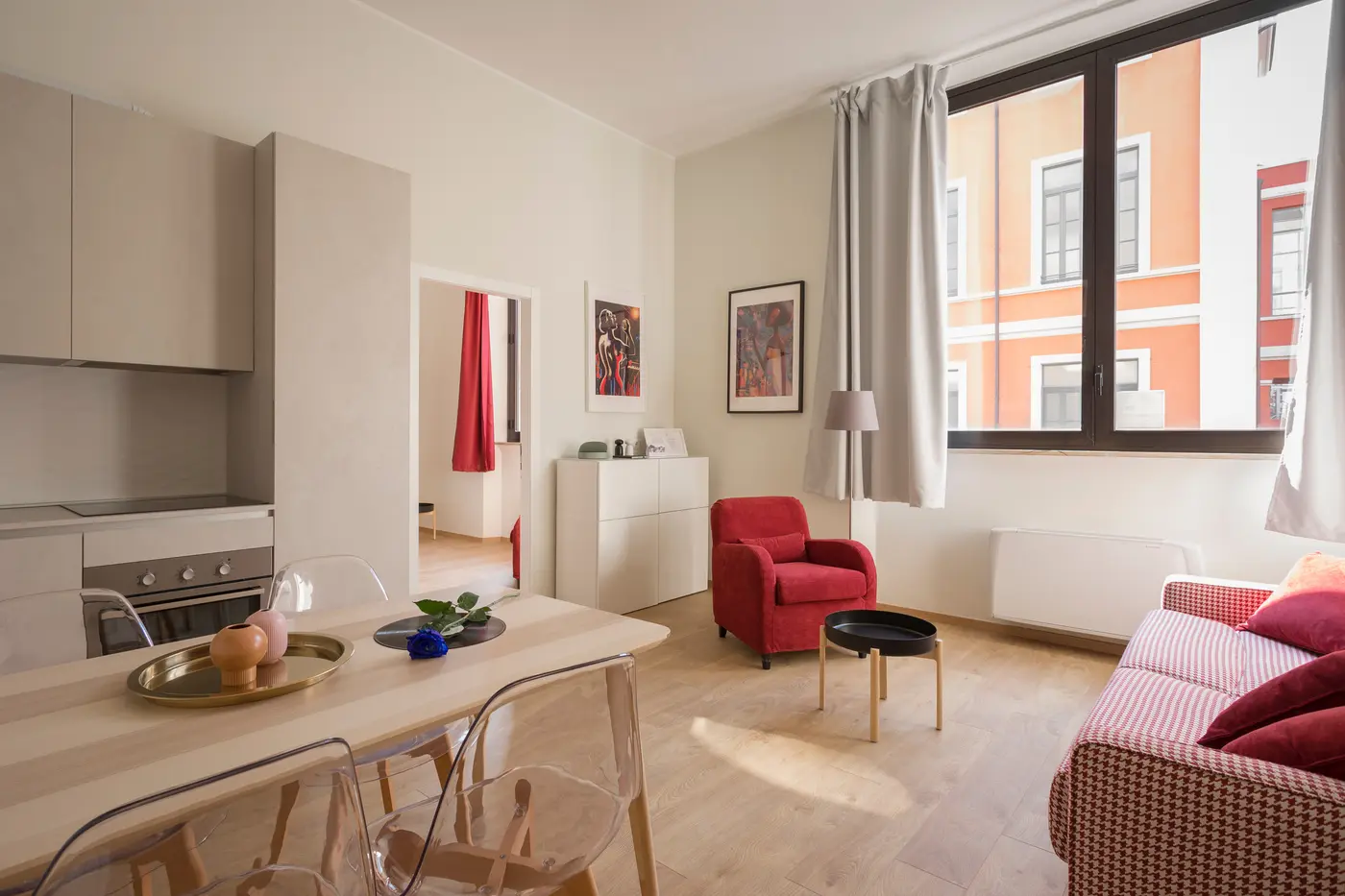 Bright living room with large windows and a sofa in afternoon sun